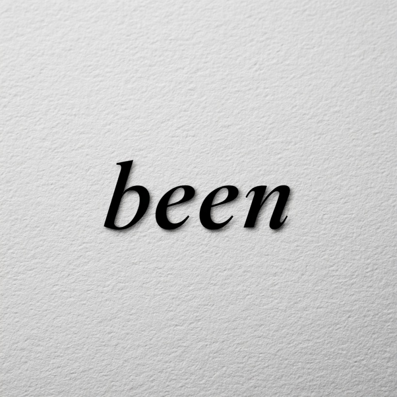 The word “been” printed in black serif font on textured white paper, highlighting its linguistic and pronunciation variations