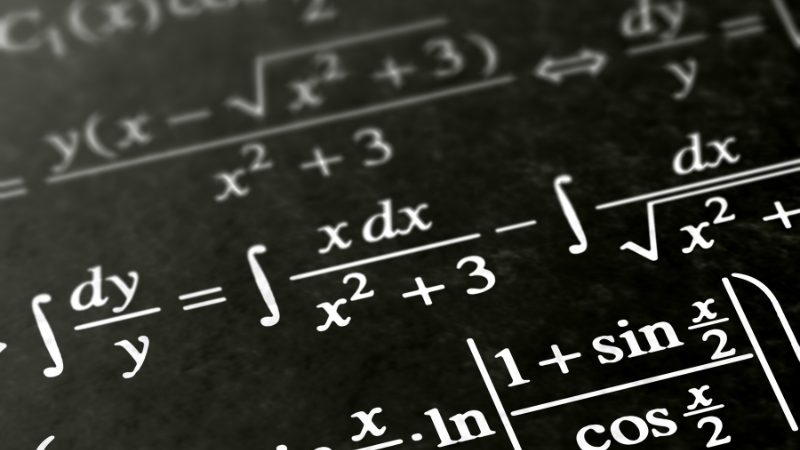 Close-up of advanced mathematical equations written on a blackboard